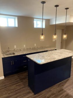 Remodeled basement kitchen with hanging lights